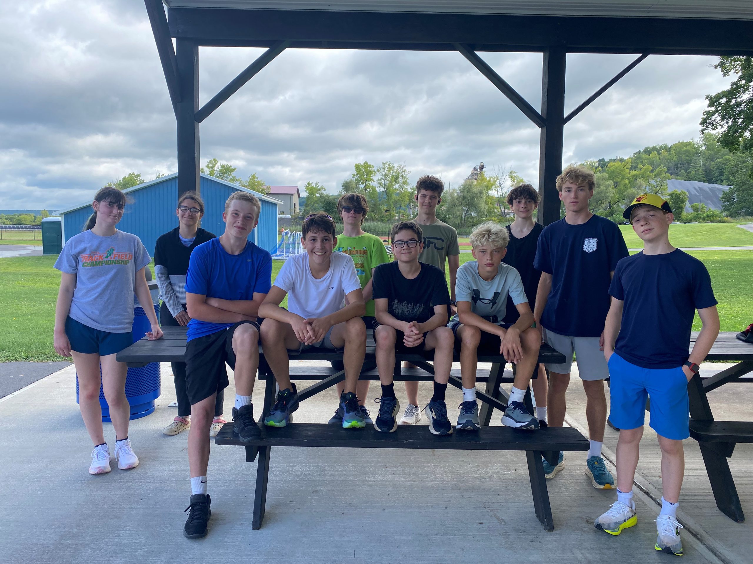 A cross country team sits on a tables