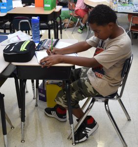 student working at his desk