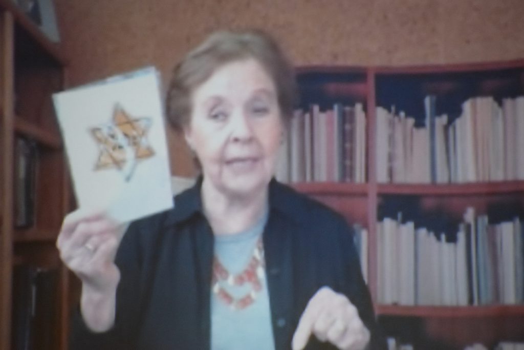 A woman holds a star of David