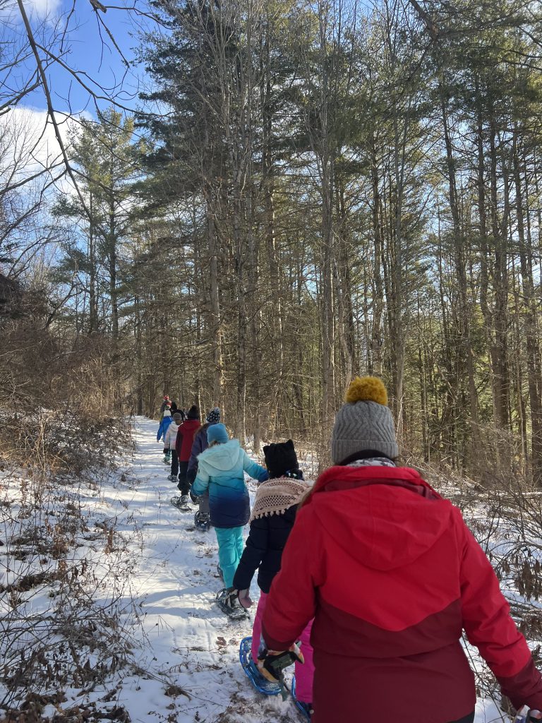 students walk on a trail