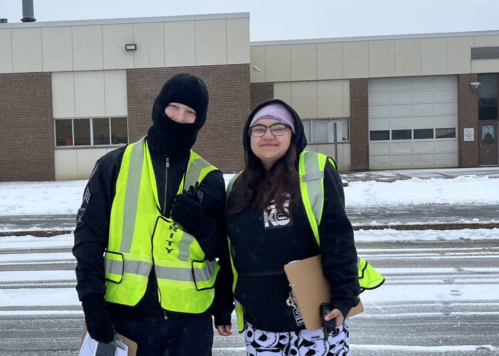 Two students stand in the cold