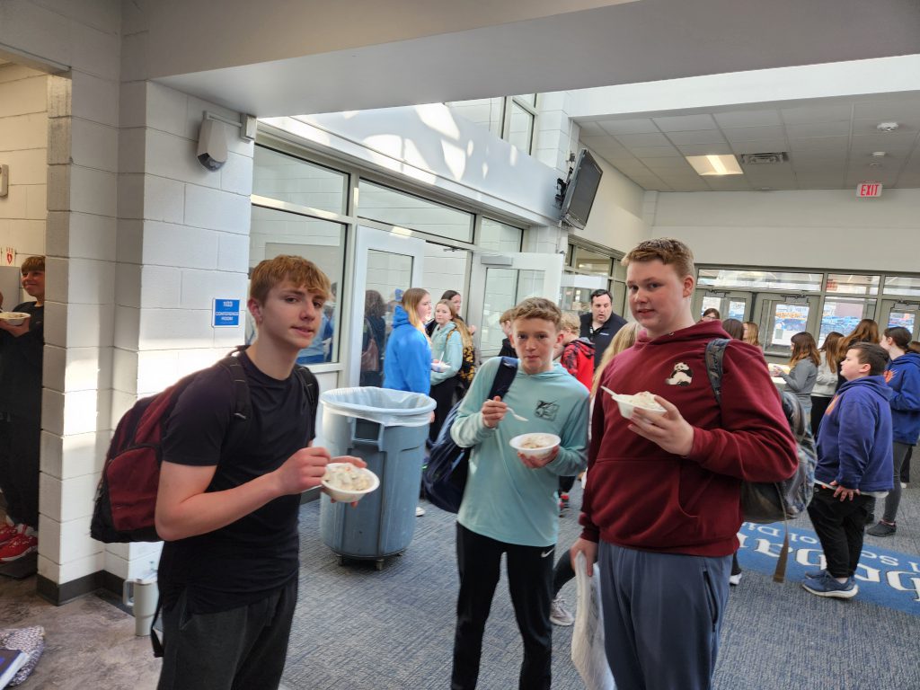 students eat ice cream in a hallway