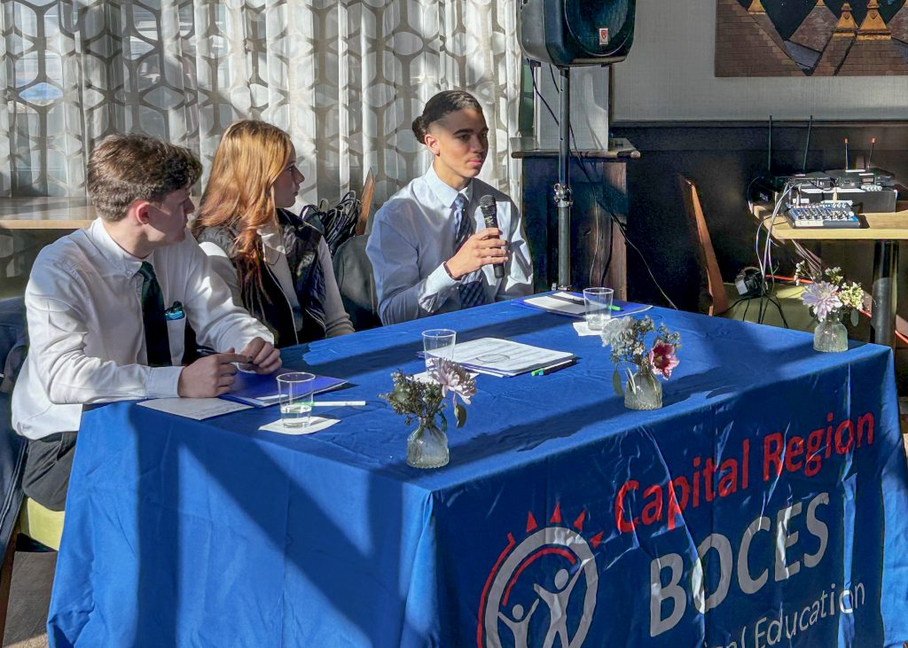 Three students sit at a table