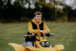 A student sits on an ATV