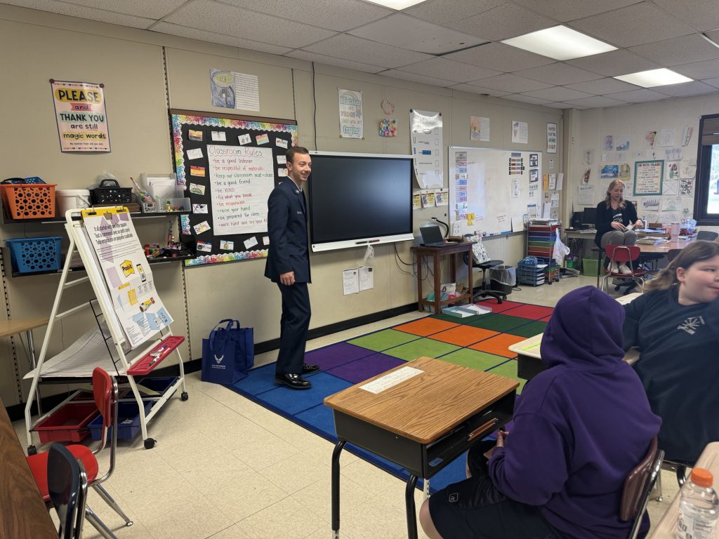 An airman presents to a class