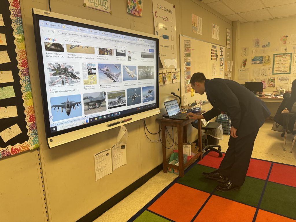 An airman works a projector