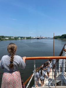 student looks out over the river