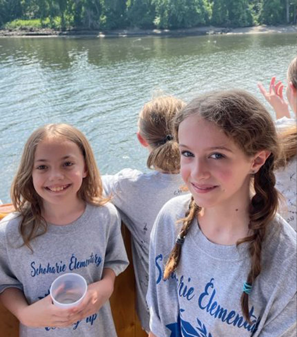 Two elementary students enjoying a river cruise during a field trip.