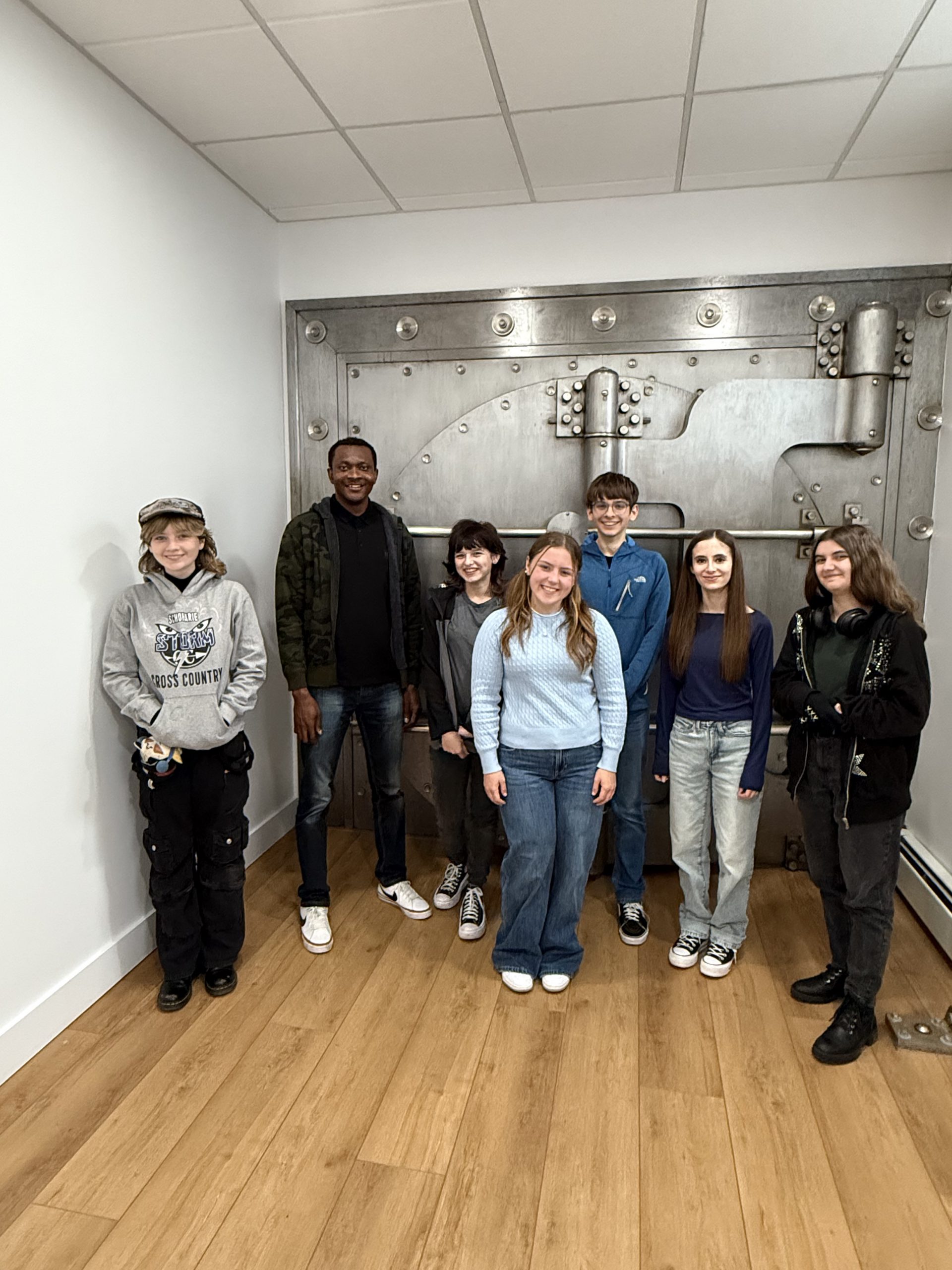 A group of students stands with an adult