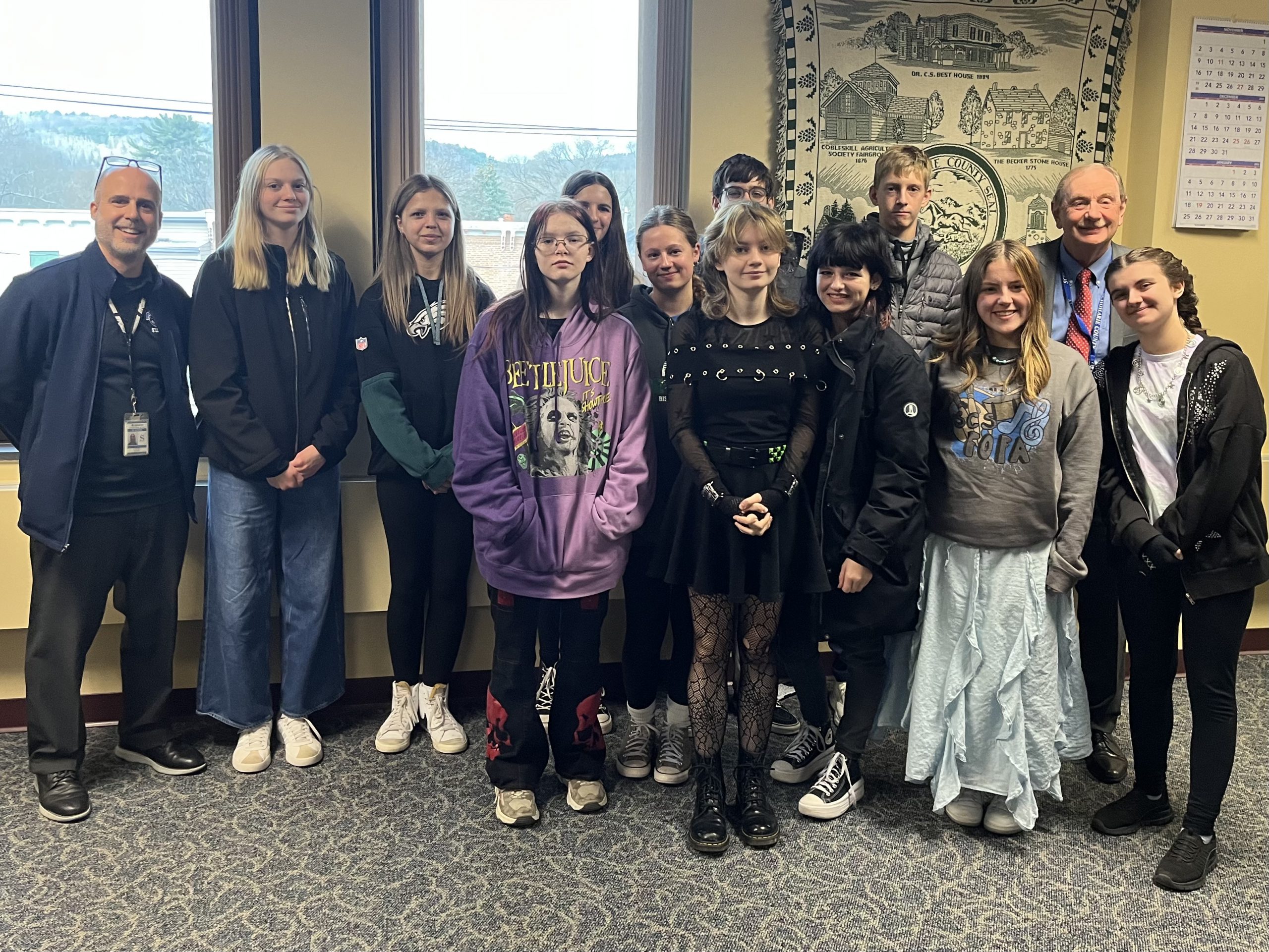 A group of students and adults stand