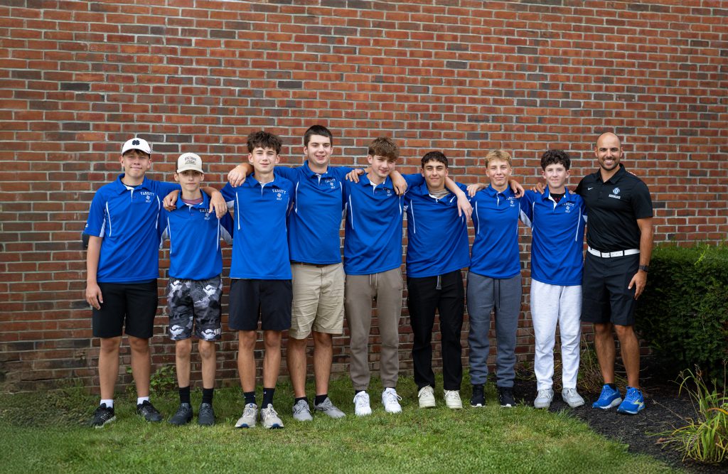 a sports team stands in front of a wall