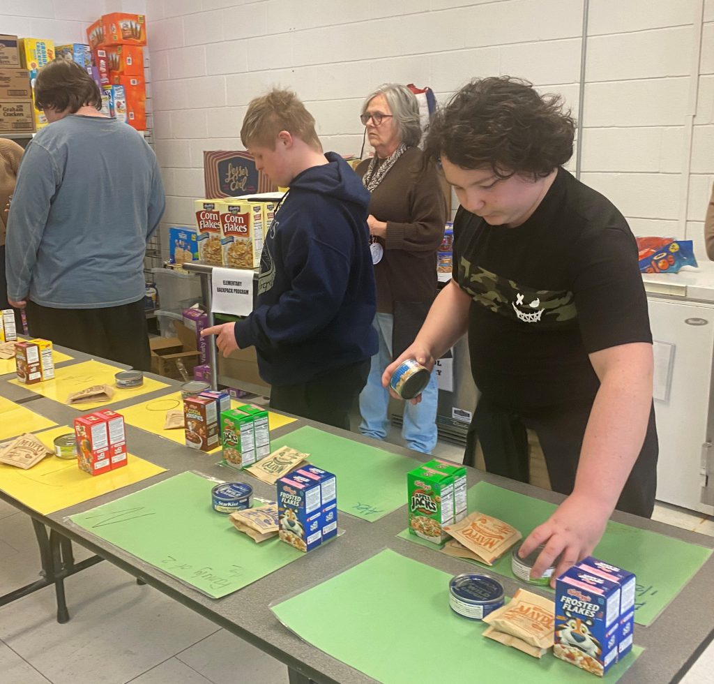 a student lends a hand in pantry