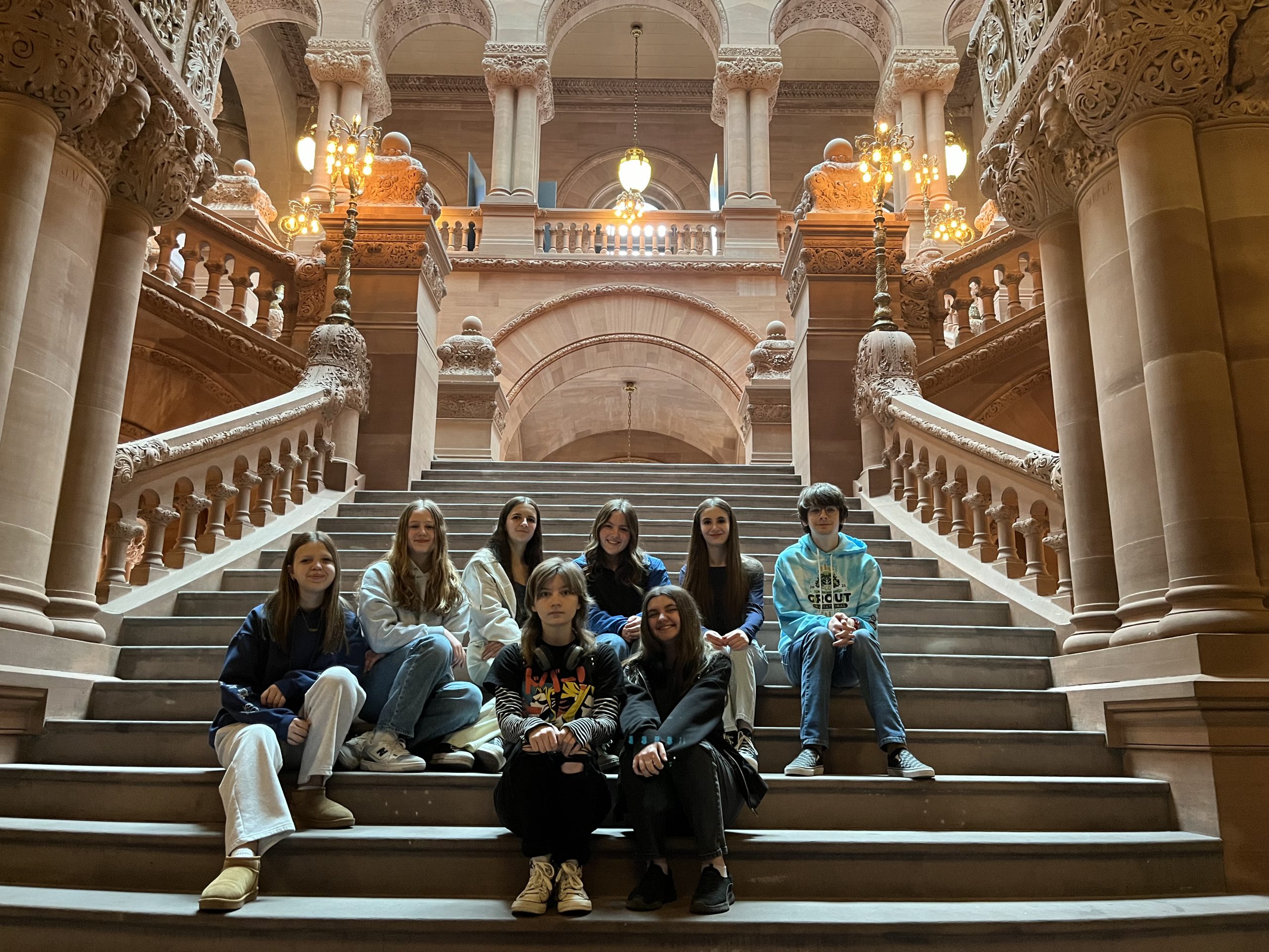 students sit on staircase