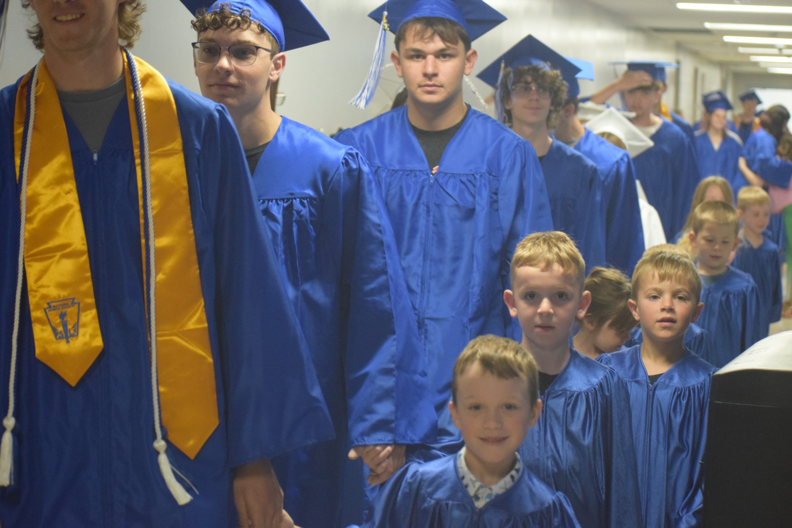 students walk in grad outfits