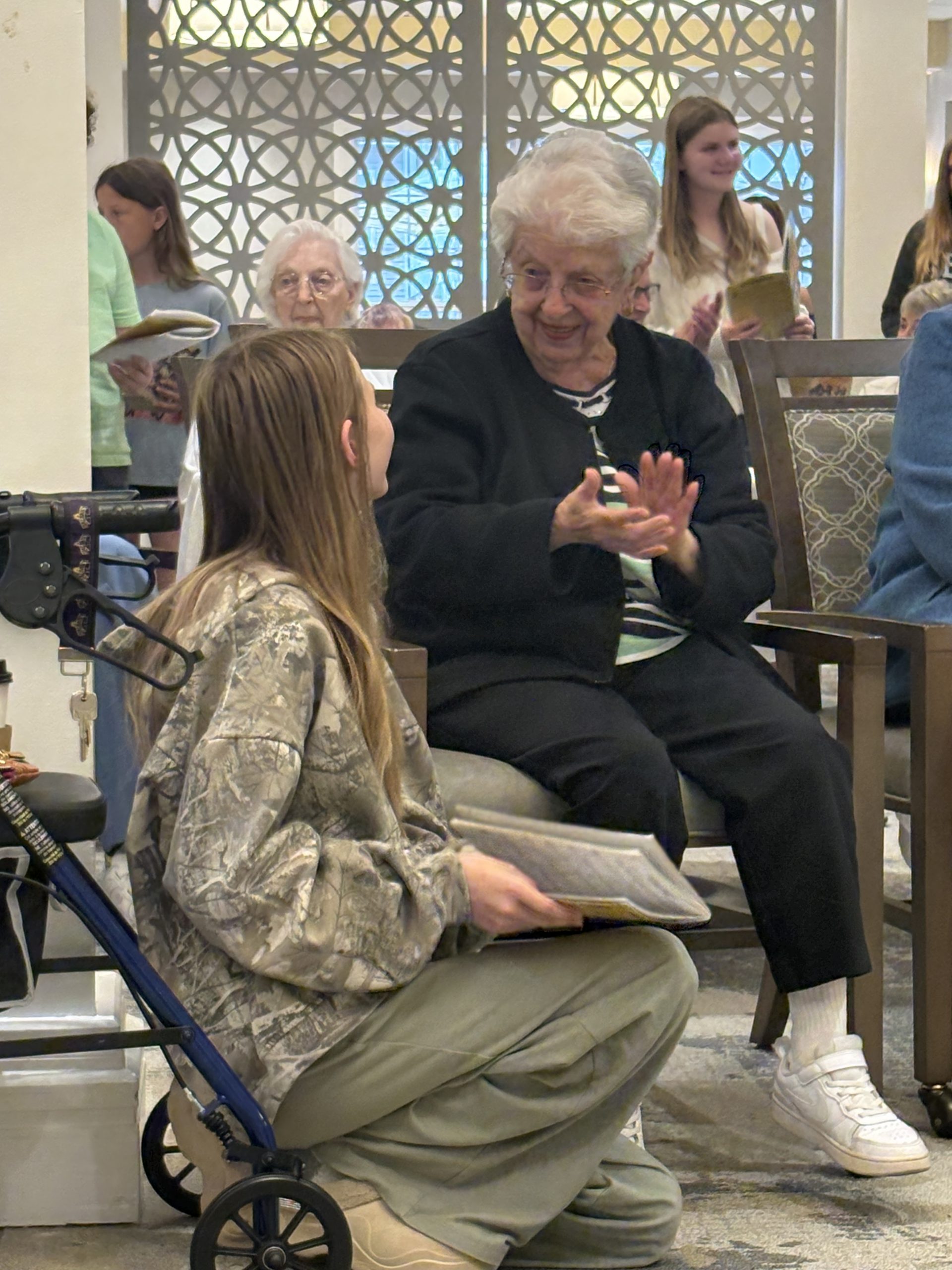 A student visits with a senior