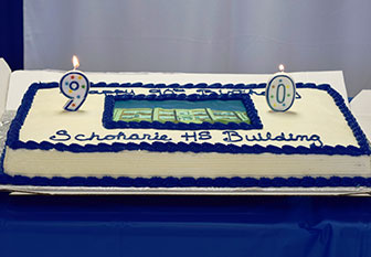 90th birthday cake. picture of school on cake with 90 candles