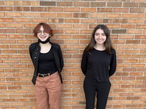 Two students stand