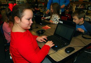 student typing on laptop keyboard
