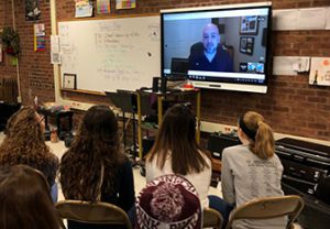 student talk to composer via tv hookup in classroom