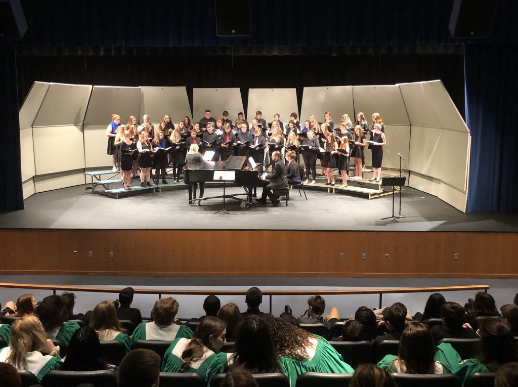 A large choral group performs