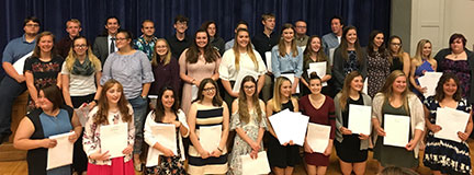 large group of students holding their award certificates