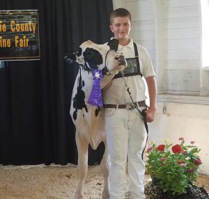 student with cow and blue ribbon