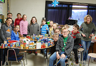 students stand with the food they collected