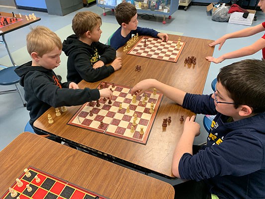 group of boys playing chess