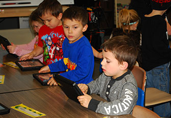kids work on iPads