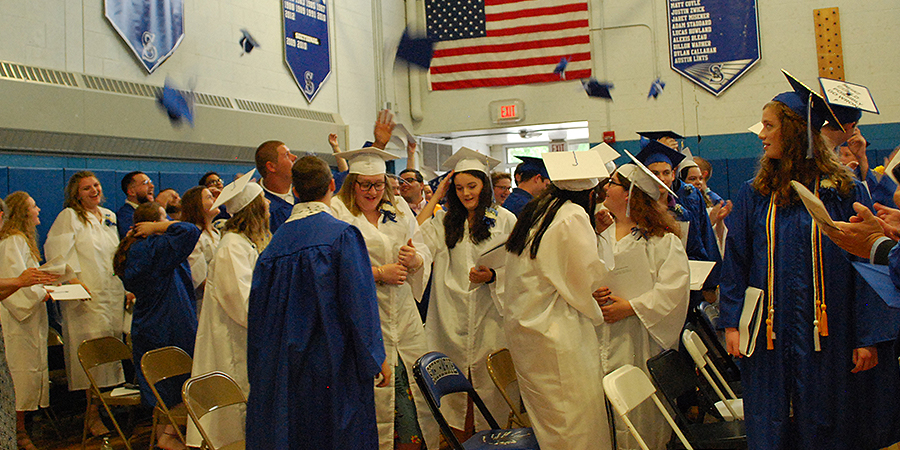 grads toss their caps in the air